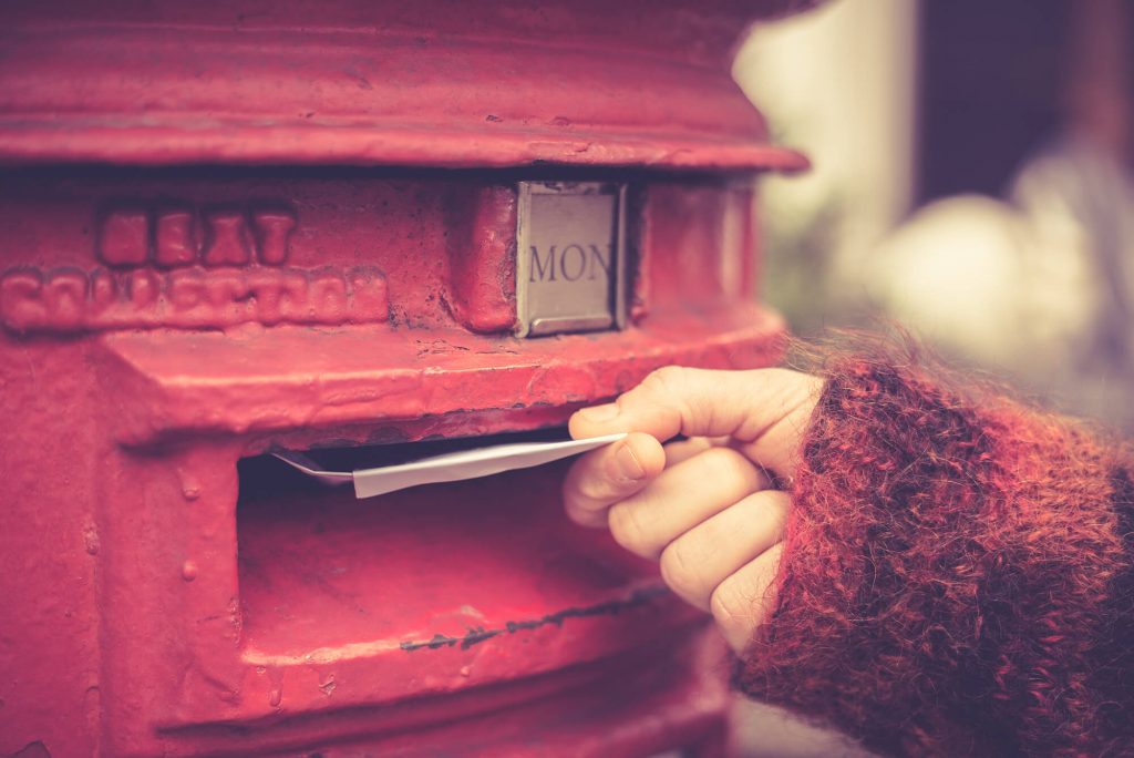 Royal Mail posting letter in letterbox